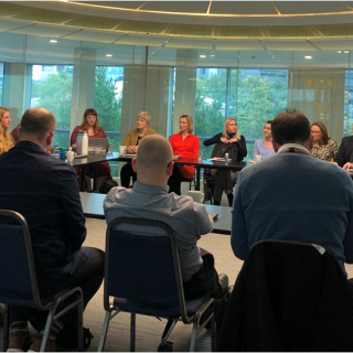 A group of people sitting around a table.