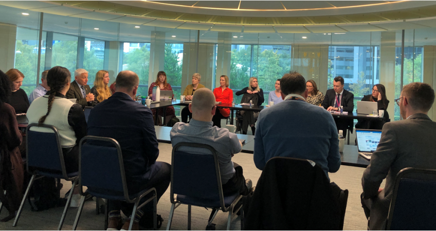 A group of people sitting around a table.