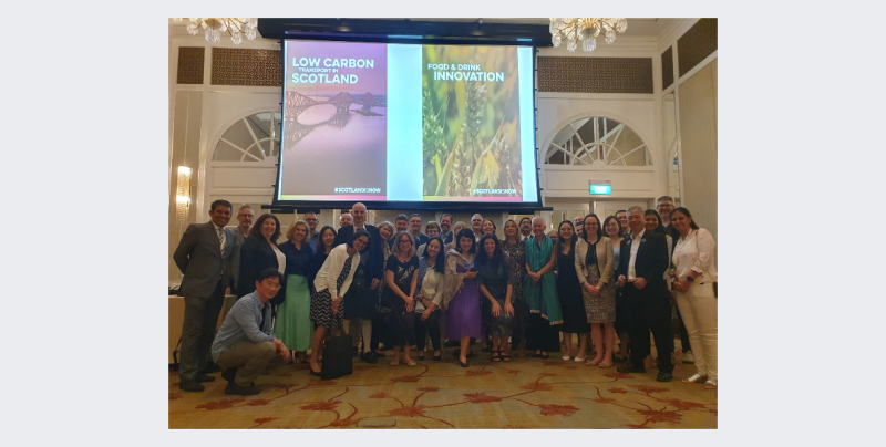 Group of delegates standing together having their picture taken.