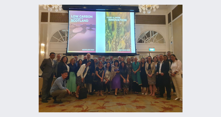 Group of delegates standing together having their picture taken.