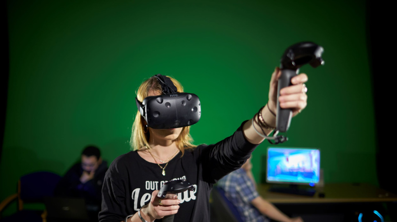 A woman wears a Virtual Reality headset