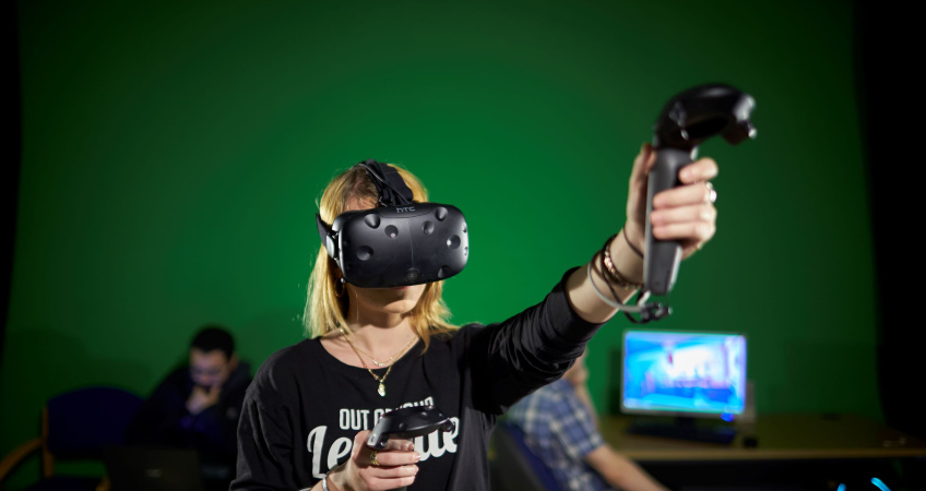 A woman wears a Virtual Reality headset
