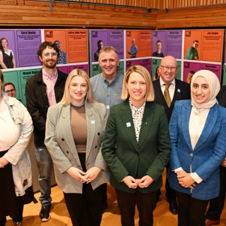 Megan, Rebecca, Jenny, Shemaa, Graham, John, Paul and Josh are standing in front of the 40 Faces gallery. Photo credit to Greg MacVean